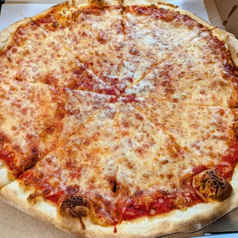 A whole Marinelli's cheese pizza, cut into eight slices, in a cardboard box.